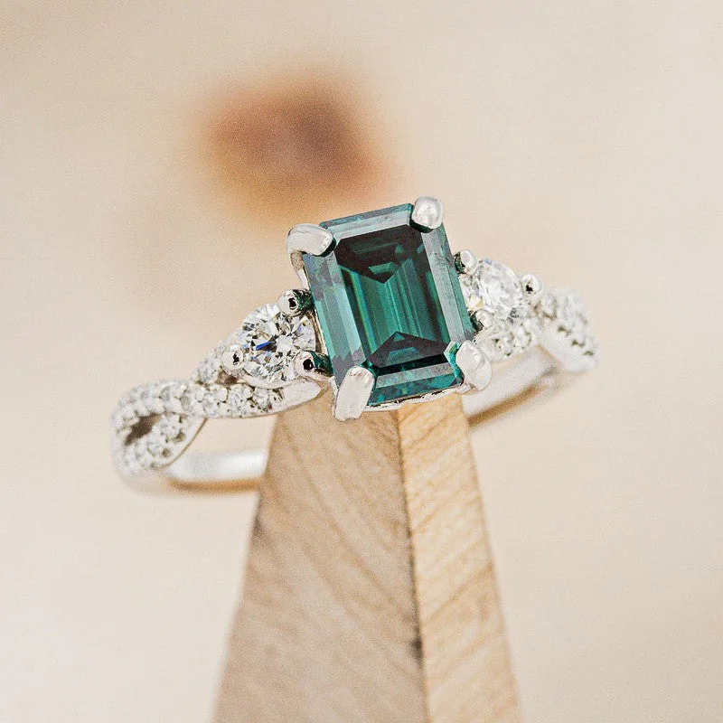 "GAIA" - EMERALD CUT MEDEINA GREEN MOISSANITE ENGAGEMENT RING WITH DIAMOND ACCENTS